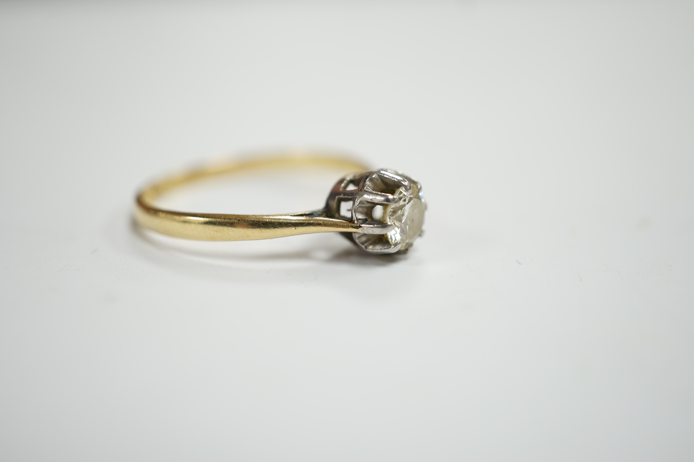 An early 20th century 18ct, plat and claw set solitaire diamond ring, size S, gross weight 2.8 grams.